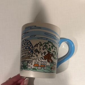 Disney Mug with Blue Handle and Colorful Theme Park Design